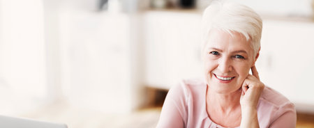 Portrait of attractive aged business lady smiling at camera