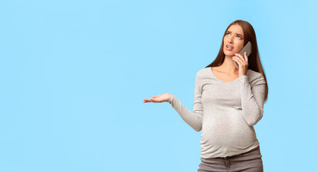 Discontented Pregnant Lady Talking On Cellphone Complaining, Gray Background, Panorama