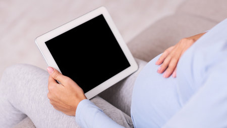 Unrecognizable Expectant Lady Using Tablet Sitting On Couch Indoor, Mockup