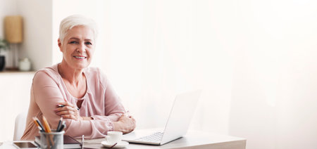 Successful happy aged lady working from home