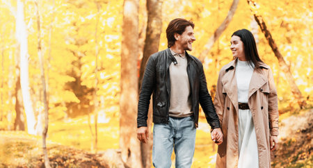 Loving cheerful couple spending time at autumn forestの写真素材