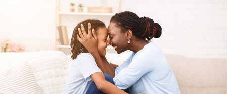 Happy black mom hugging her little girlの写真素材