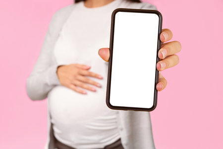 Unrecognizable Pregnant Girl Showing Pill To Camera Standing, White Background