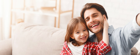 Positive portrait of father and daughter taking selfie