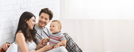 Family Bonding Moment in Bright Room With Parents and Babyの写真素材