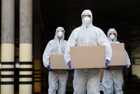 People in protective suits and masks delivering vaccine