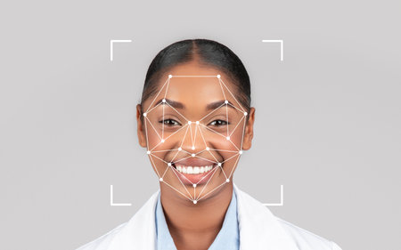 Smiling healthcare professional using facial recognition technology indoorsの写真素材