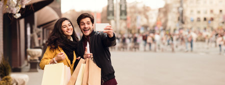 Couple recording video for fashion blog after shopping in mall