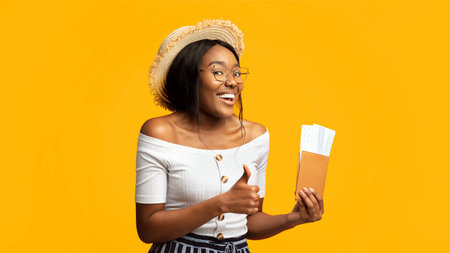 Black Woman Holding Tickets And Passport Gesturing Thumbs-Up, Studio Shot