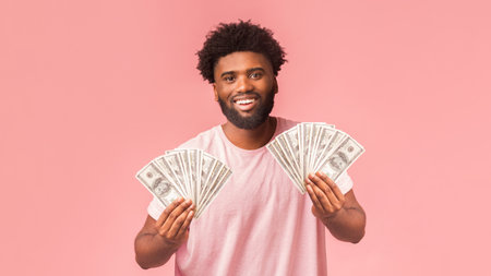 Happy black man holding smartphone and showing bunch of money