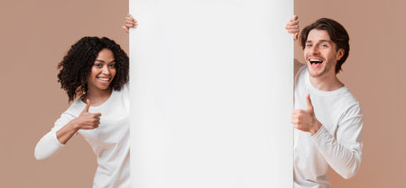 Happy Interracial Couple Holding White Advertising Board And Showing Thumbs Upの写真素材