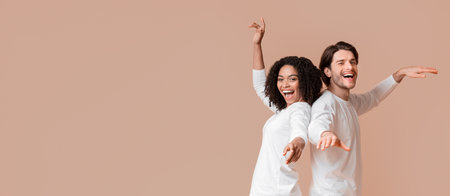 Joyful interracial couple dancing back to back, having fun together