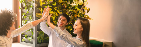 Excited multiethnic team giving each other high five