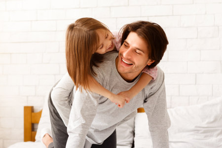Preschool girl spending time at home with dadの写真素材