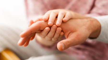 Close up of kid holding father palm with two handsの写真素材