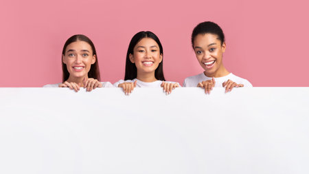 Three Diverse Women Holding Blank White Board, Pink Background, Mockupの写真素材