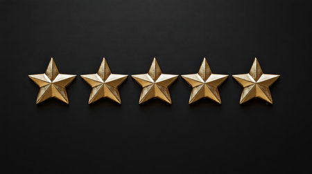 Five gold stars arranged in row on dark background, symbolizing achievement and excellenceの素材