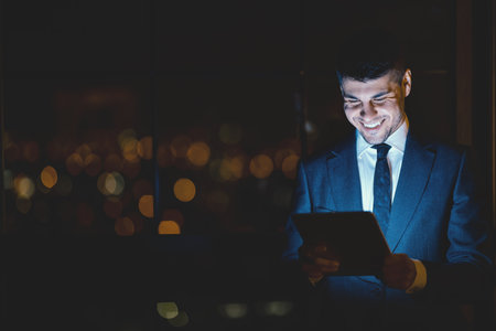 Happy Businessman Using Tablet Standing In Modern Officeの写真素材