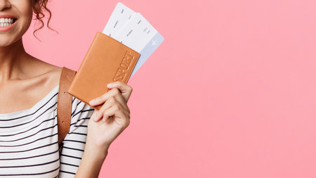 Happy woman with passport and retro cameraの写真素材