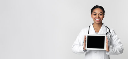 Digital Tablet With Black Screen In Hands Of Afro Female Doctorの写真素材