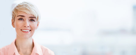 Female Entrepreneur Smiling At Camera Posing Near Window Indoorの写真素材