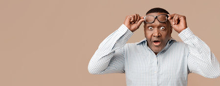 Shocked mature african american man looking at camera