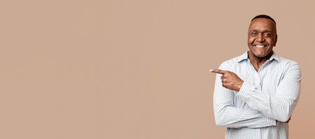African american mature man pointing aside at empty spaceの写真素材