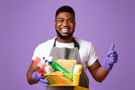 Positive Black Man Holding Container With Detergents And Showing Thumb Upの写真素材