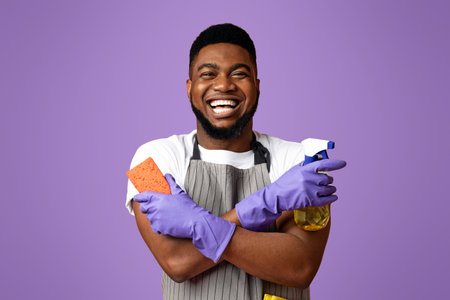 Joyful Black Man With Household Tools In Hands Ready To Cleanの写真素材