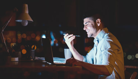 Businessman Talking On Phone Using Loudspeaker Working In Modern Officeの写真素材
