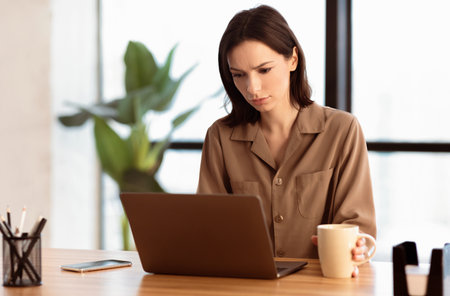 Sad european manager using personal computer at homeの写真素材