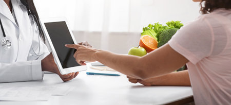 Woman nutritionist using digital tablet in office, making patients anamnesisの写真素材