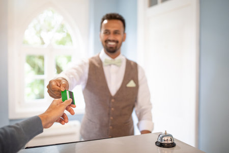 A man is paying with a credit card at a hotel reception deskの写真素材
