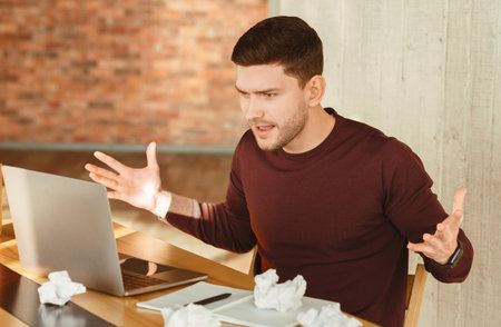 Angry Employee At Laptop Gesturing Having Problem Sitting In Office