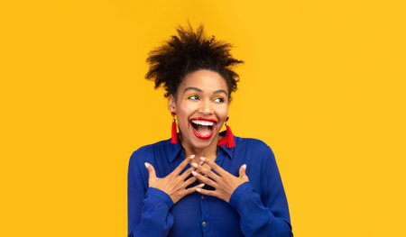 Headshot of black woman holding hand on her breast