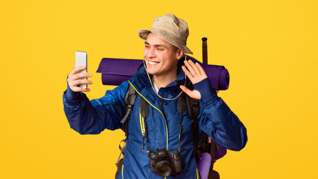 Male hiker with big backpack taking selfieの写真素材