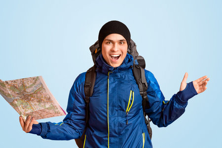 Emotional backpacker with map in hand exclaiming happiness