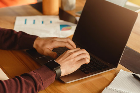Male Hands Working On Laptop Typing At Workplace In Office