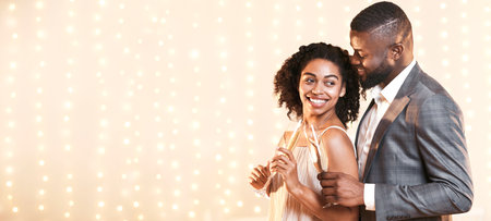 Black couple in love drinking champagne, having dateの写真素材