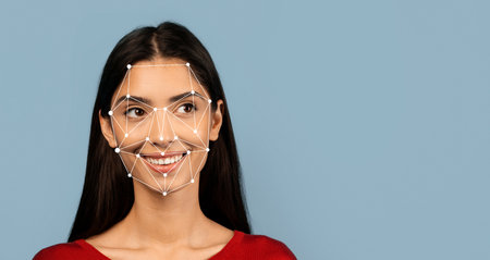 Woman smiling with facial recognition technology overlay in a studioの写真素材