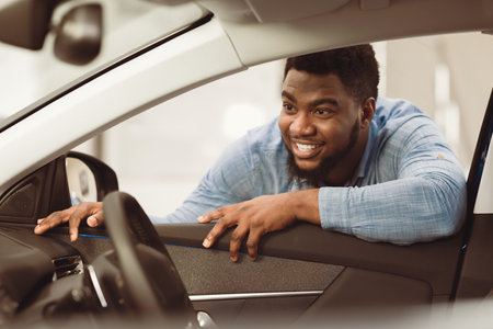 Man Buying Car Looking At Vehicle Interior In Dealership Centerの写真素材