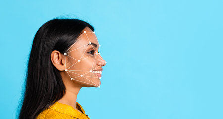 Profile view of a woman with facial recognition overlay against blue backgroundの写真素材
