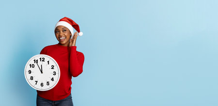 Joyful woman in a Santa hat holds a clock while celebrating the holidays