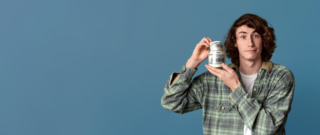 Big luck concept. Rich young guy holding dollars on color backgroundの写真素材