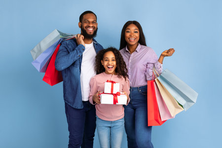 African American cheerful people holding shopping bags and giftの写真素材
