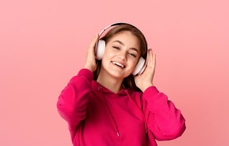 Relax and music. Teen girl in wireless headphones enjoying favorite songの写真素材