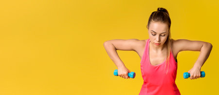 Motivated Fitness Woman Exercising With Dumbbells On Pink Studio Background. Workout Concept....