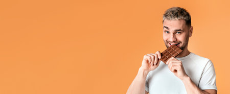 Unhealthy food. Ironic millennial man eating chocolateの写真素材