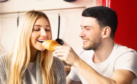 Husband and wife enjoying their family brunch together in kitchenの写真素材