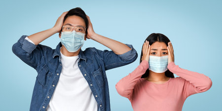 Coronavirus Panic. Asian Couple In Protective Masks With Scared Face Expressionの写真素材